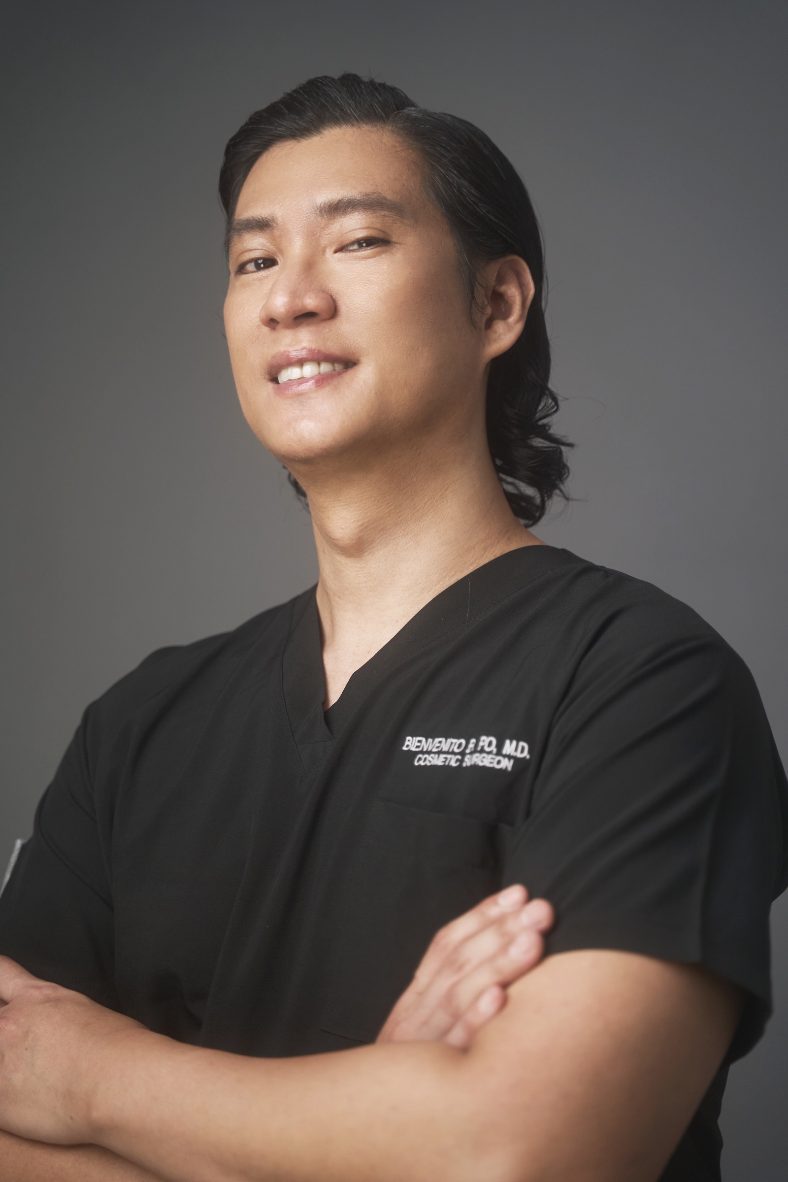 Portrait of Dr. Bien Po in black surgical scrubs